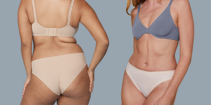 Two models are posing in front of a muted blue background. The model on the left is seen from the back, wearing the Base T-Shirt Bra in Beige and the No-Show Bikini in Beige. The model on the right is shown from the front, wearing the Base Unlined Bra in Steel and the Bliss Bikini in Rose.